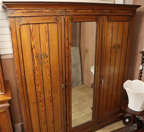 A large late Victorian pitched pine three door compactum wardrobe W.188cm